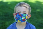 Child Wearing a Face Mask Attends Funeral During COVID-19 by Sarah R. Scott