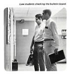 Caption: Law students checking the bulletin board. by University of New Mexico School of Law